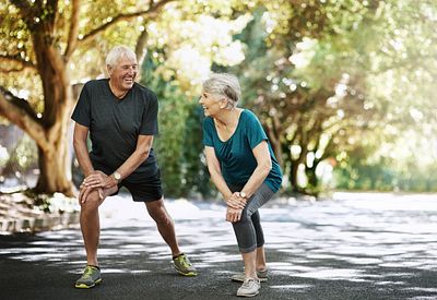 Youthful elderly couple exercising in a park